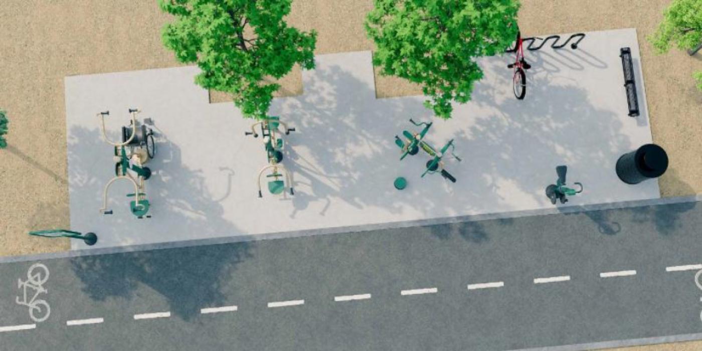 An aerial 3D rendering of a proposed outdoor fitness station along a paved trail. The station features several green fitness equipment pieces arranged on a concrete pad, surrounded by sandy ground and three shade trees. A bicycle rack, a trash receptacle, a bench, and a parked red bicycle are also shown. A shared bike and pedestrian lane runs along the bottom of the image.