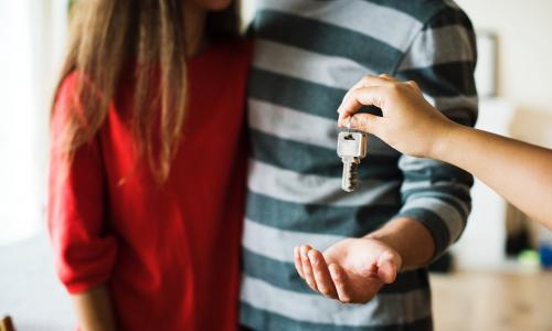 Stock photo of a couple receiving the keys to their home.