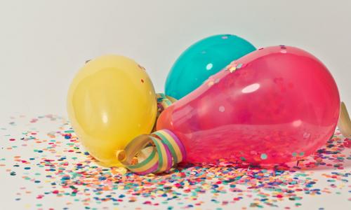 Stock photo of balloons and confetti.