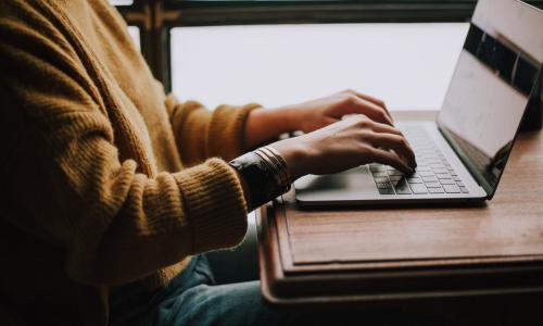 Stock photo of someone on a computer.