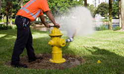 Staff flushing a fire hydrant