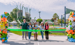 Garden Grove City Council posing for a picture behind the Woodbury Park ceremonial ribbon.