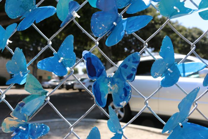 Hand-painted blue and marbled butterflies can be seen at the corner of Acacia Parkway and Grove Avenue.