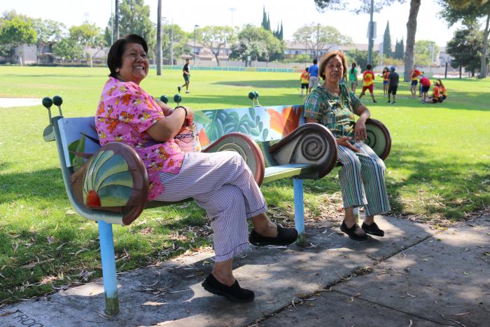 Park goers enjoy the snail family-inspired bench at Village Green park. 